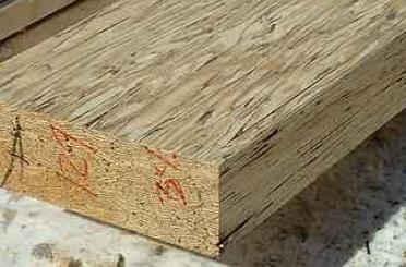 a piece of wood with red writing on it